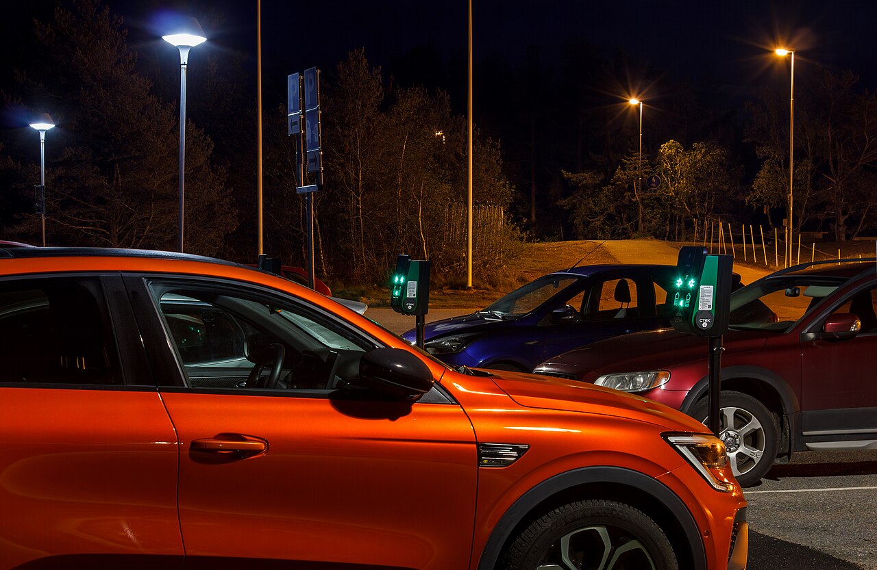 Electric vehicle plugged in and charging overnight at home