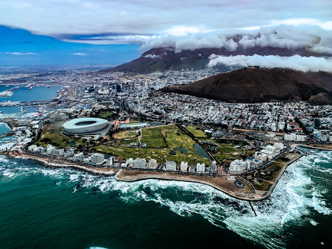 Aerial view of Cape Town's CBD and Atlantic Seaboard with Table Mountain draped in clouds and the stadium visible