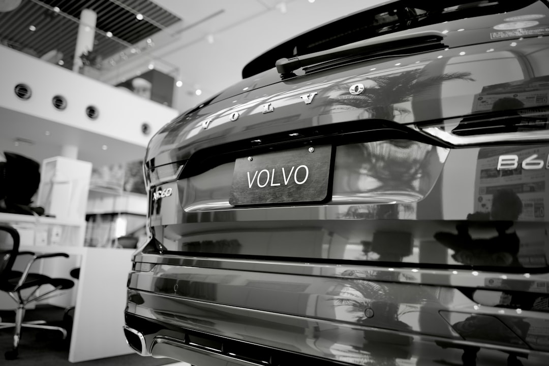 Rear view of a Volvo EX30 compact electric SUV in a showroom, displaying the Volvo badge and EX30 model designation.