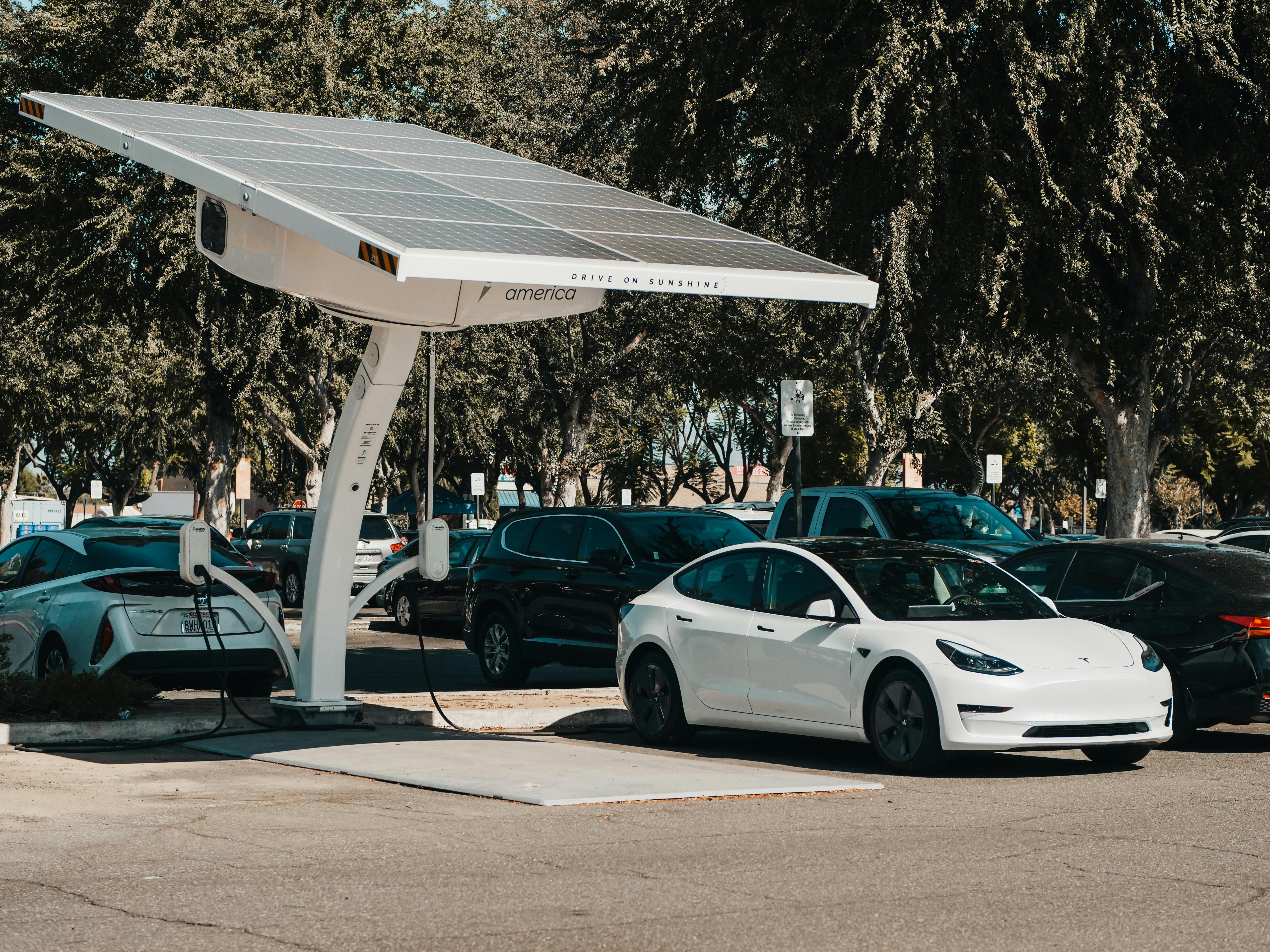 An electric vehicle parked under a solar PV canopy