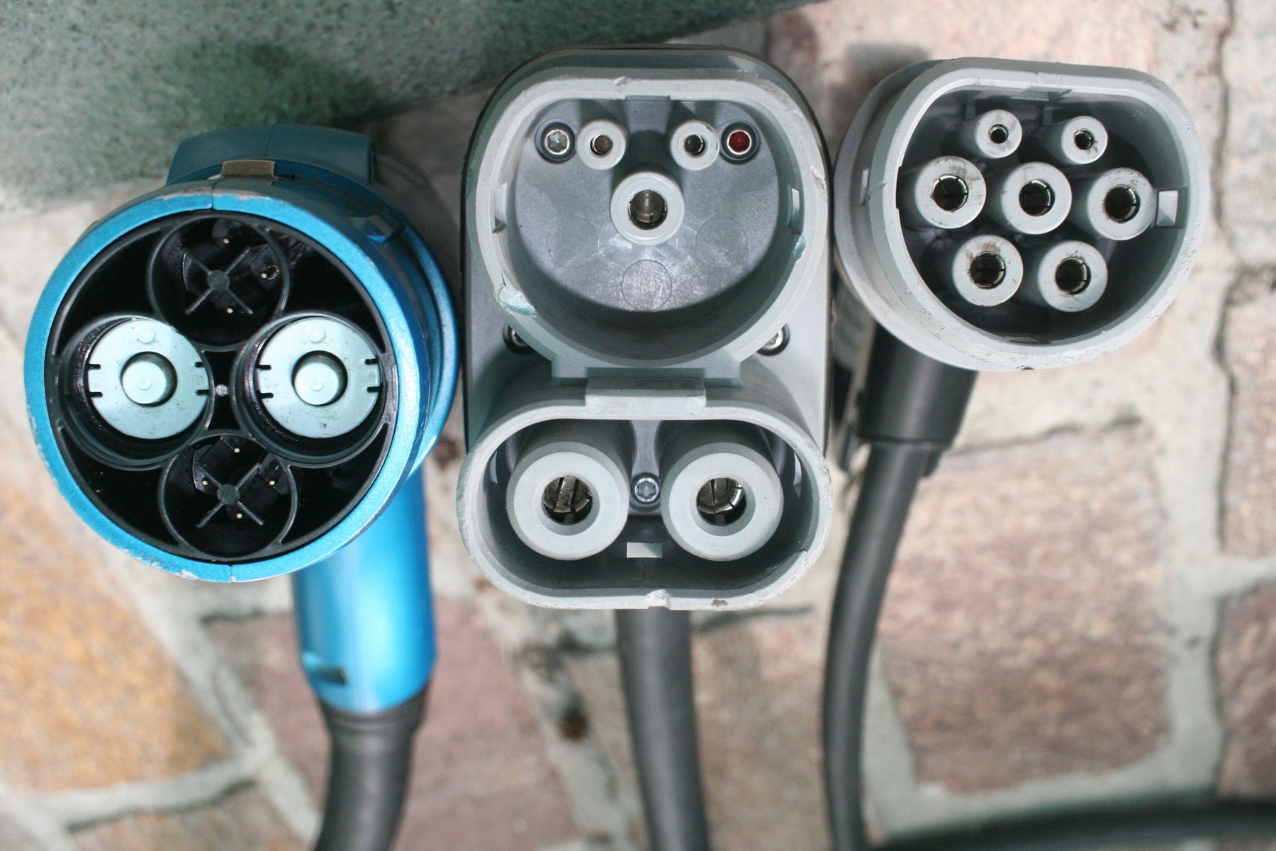 Three EV charging connectors side by side: CHAdeMO, CCS2 and Type 2