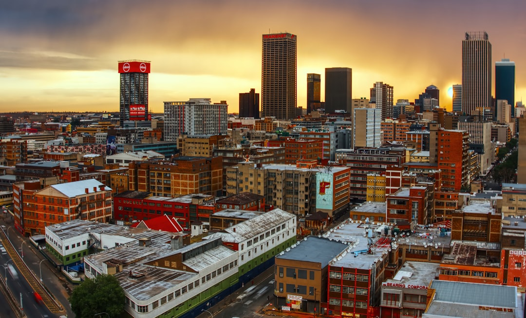 Aerial view of Johannesburg city center showing modern high-rise buildings and urban landscape at golden hour
