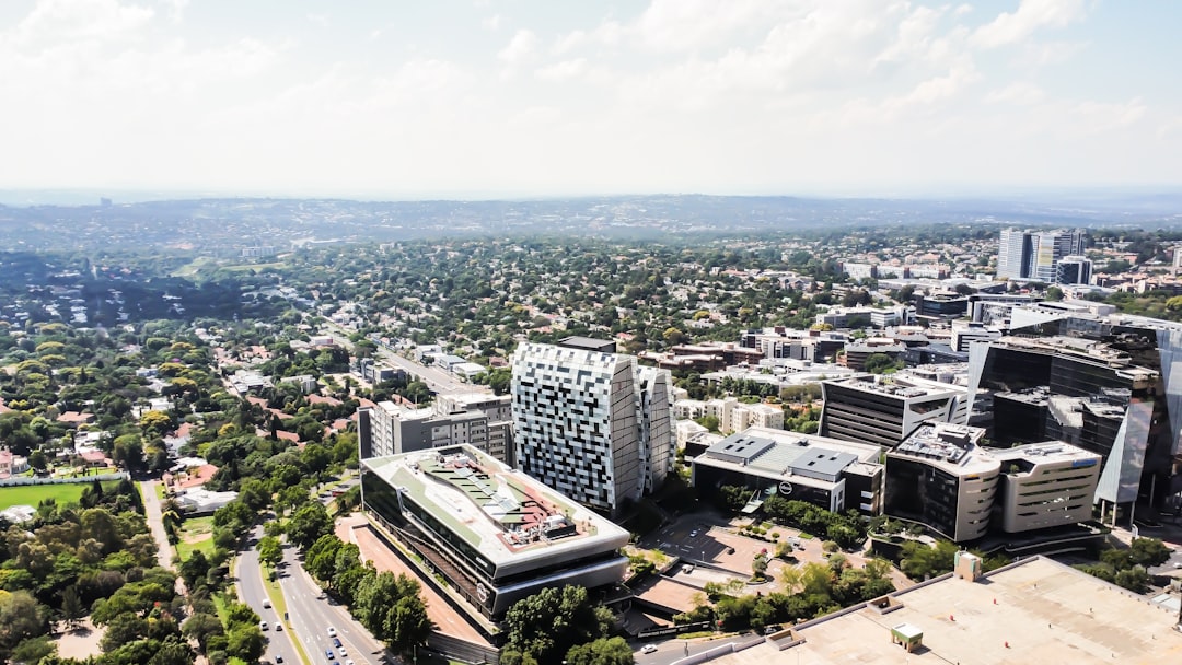 Aerial view of modern business district with office towers, contemporary buildings, and tree-lined streets