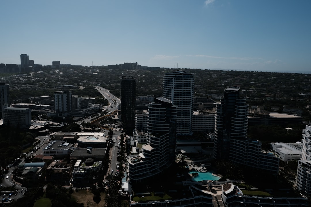 Aerial view of modern high-rise apartment buildings and residential complexes with curved architecture and swimming pools