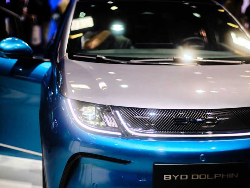 a close up of the front of a blue and white car