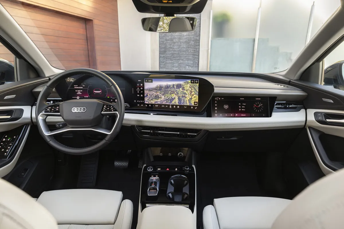 Audi electric vehicle interior dashboard with steering wheel, dual digital displays, and modern center console technology