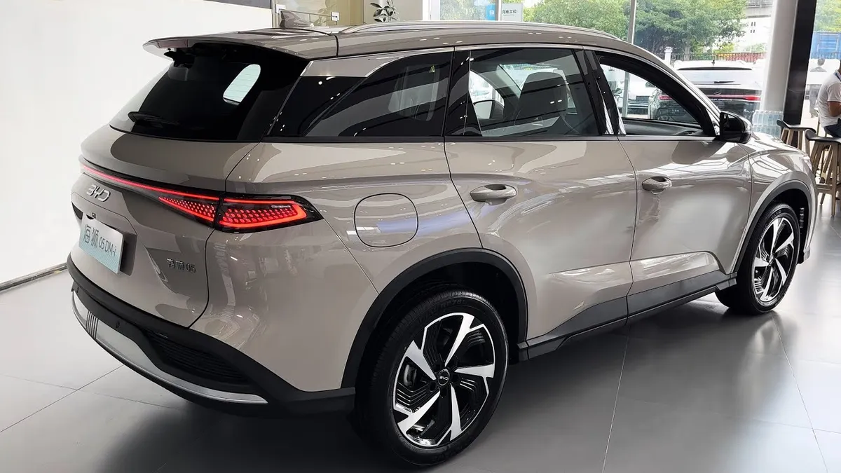 BYD Sealion 6 PHEV SUV in gray, parked indoors showing front three-quarter view with LED taillights