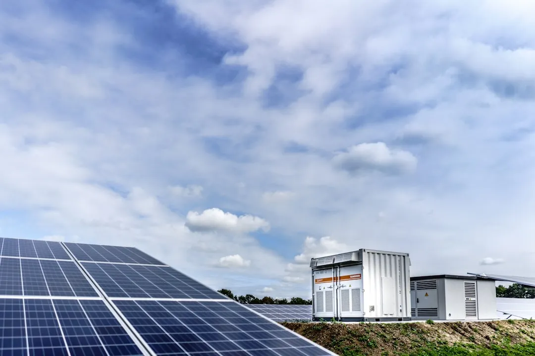 Solar panel array with battery storage containers and power equipment at renewable energy charging station